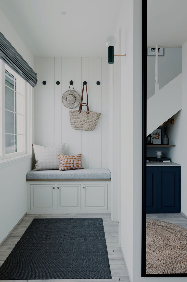 Welcoming entrance hall with built-in bench seating, shiplap panelling and natural light